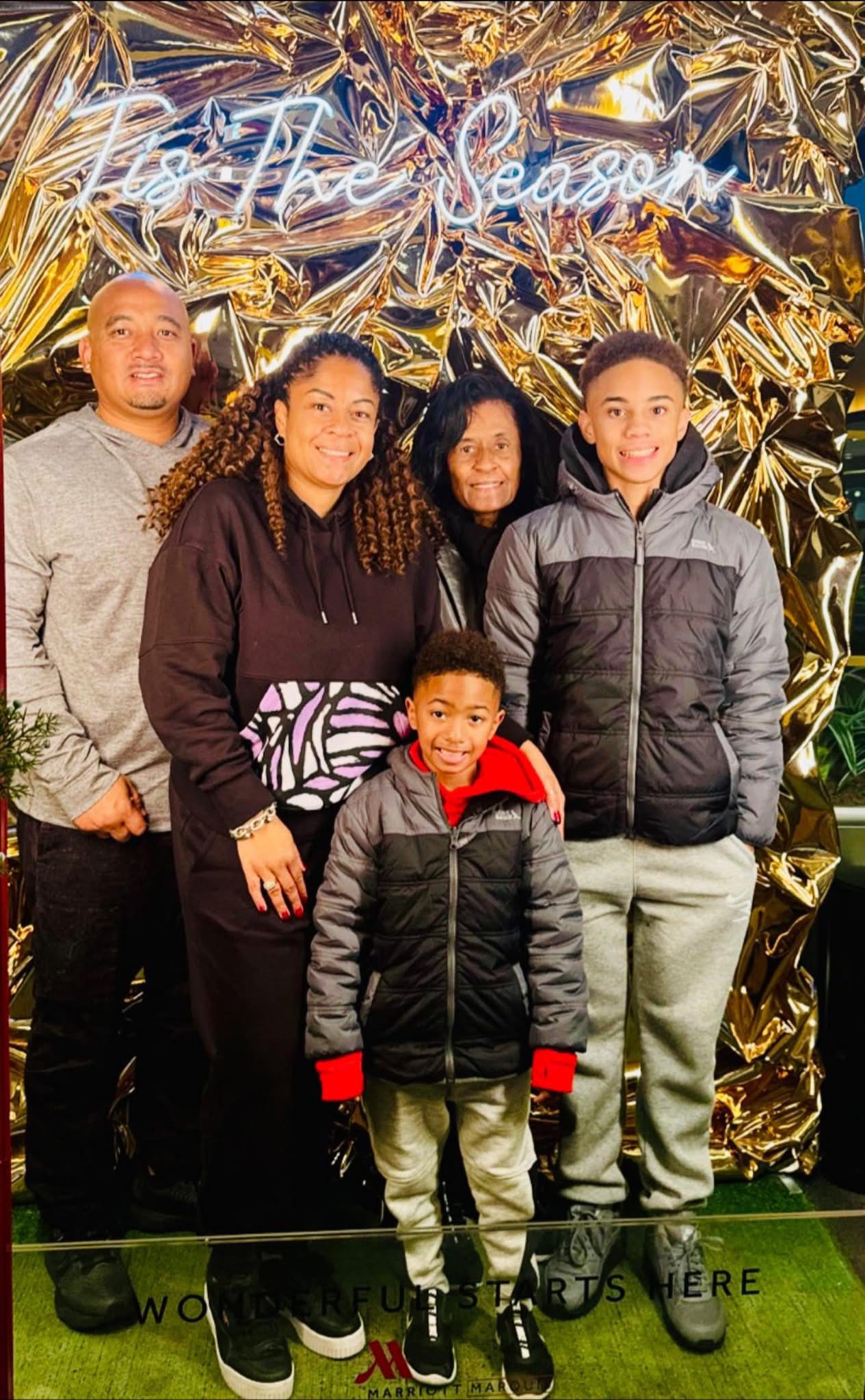 Angela with her mother, husband, and sons during the holidays